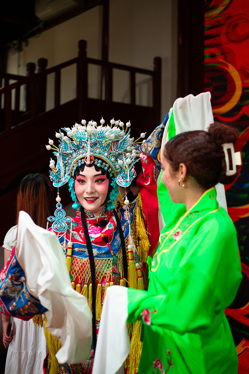 an elaborately costumed performer with their face painted